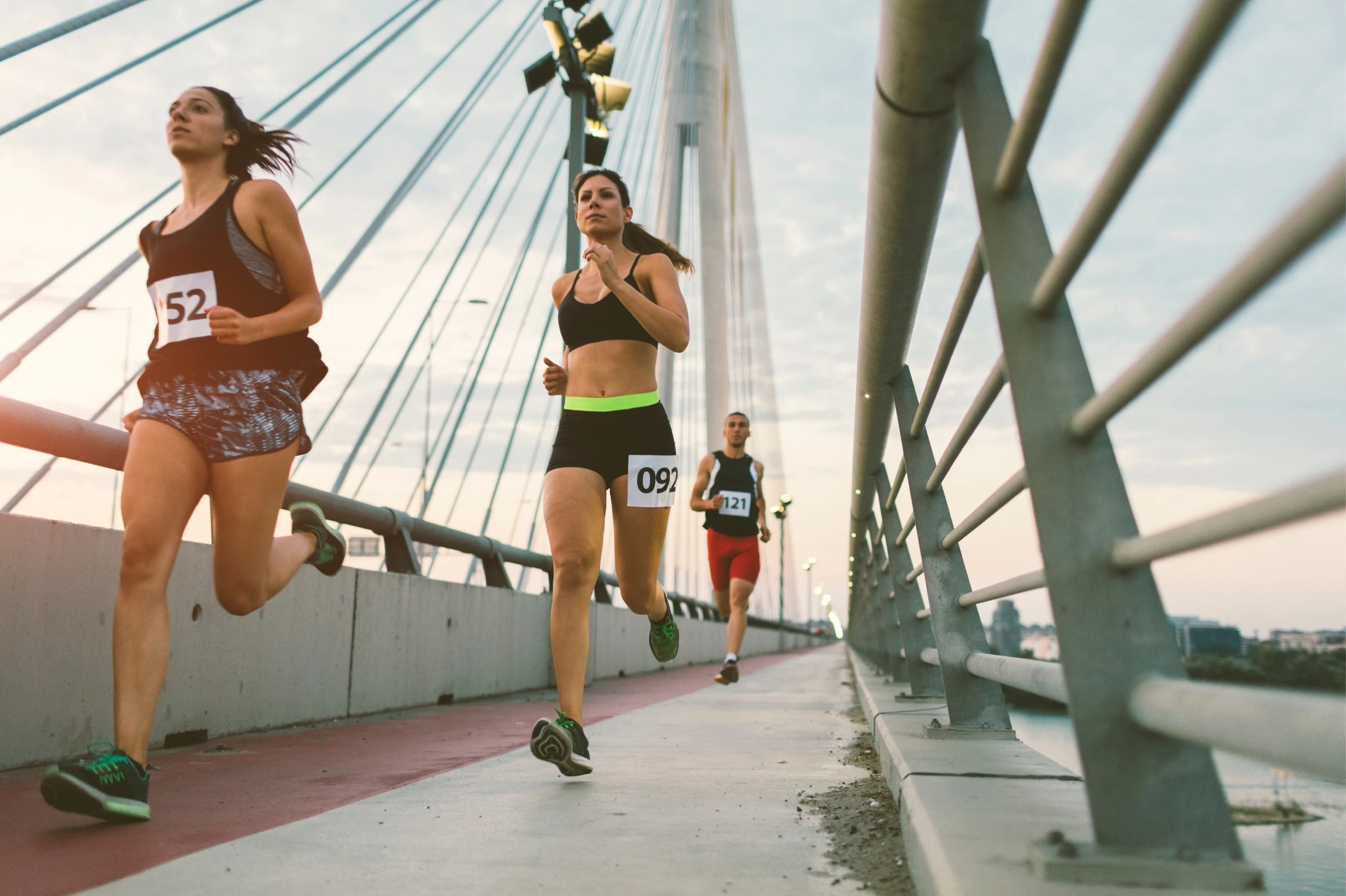 People running a marathon across a bridge.