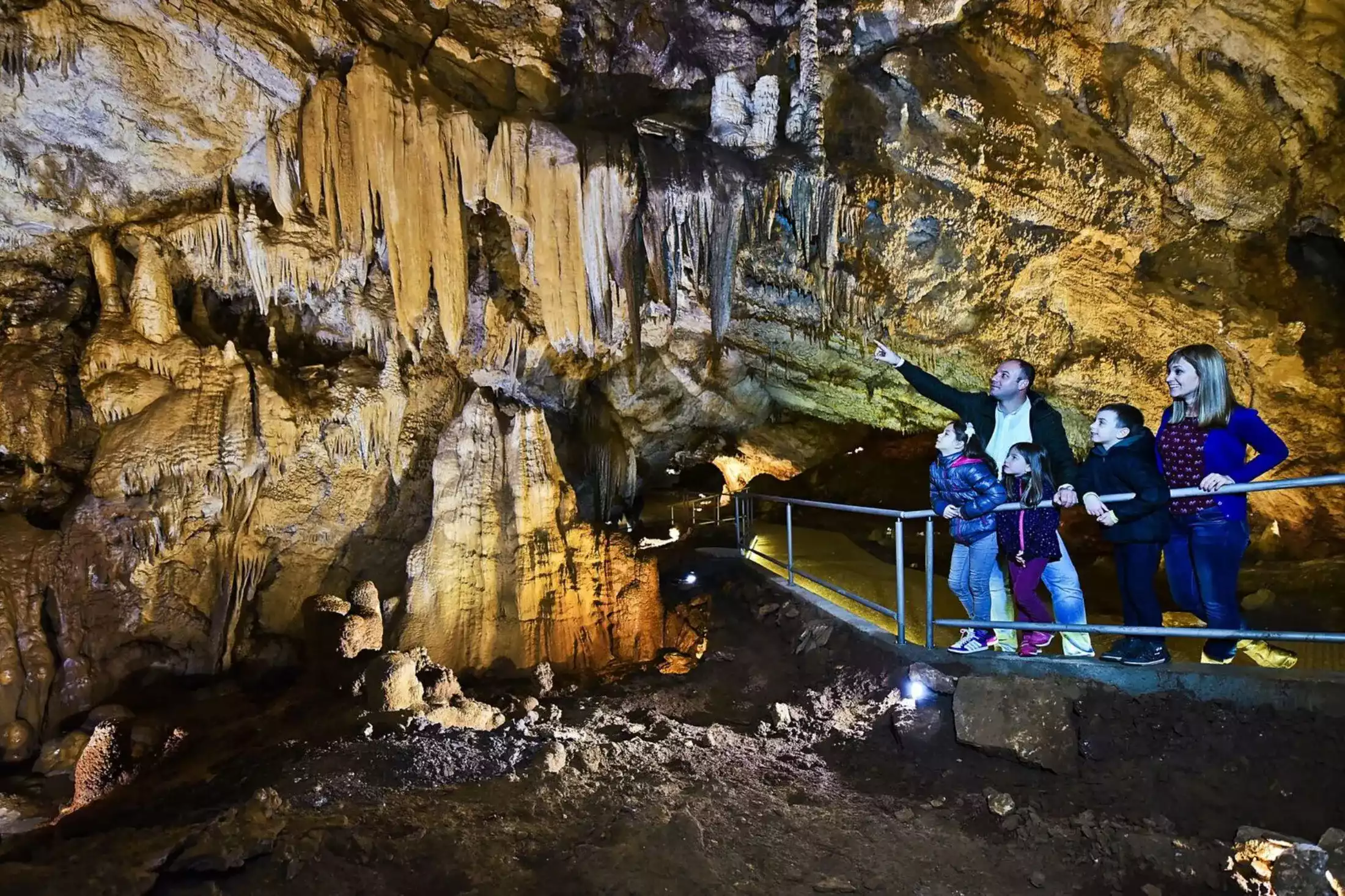 Family visiting Lipa Cave in Montenegro